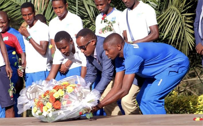 L-R: Rayon Sports captain, Eric Ndayishimiye, president Dennis Gacinya and coach Djuma Massoudi lay a wreath at a mass grave at the Kigali Genocide memorial. / Courtesy photo