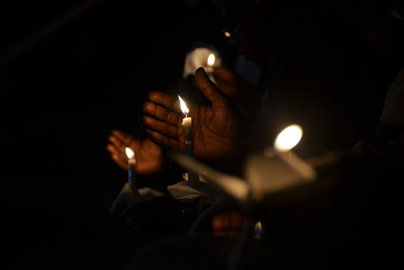 Mourners hold lit candles during a night of remembrance at Kimihurura Sector in Kigali last year. / Sam Ngendahimana