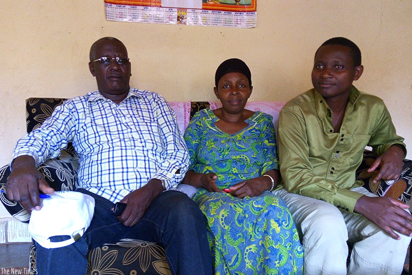 Pastor Mitsindo (L), his wife and one of their children in their home in Gasabo District on Tuesday. Emmanuel Ntirenganya. 