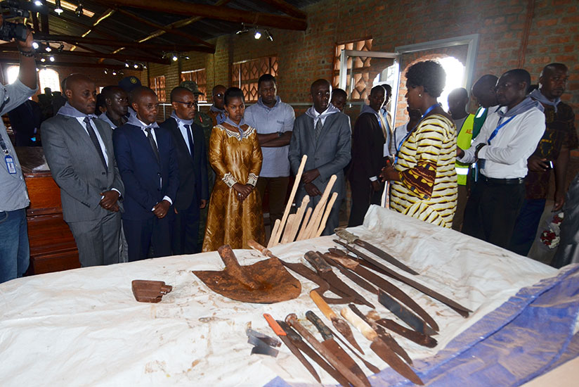 Kaboneka and other officials look at some of the tools that perpetrators used to butcher the Tutsi inside Ntarama Catholic Church in Bugesera District. / Sam Ngendahimana