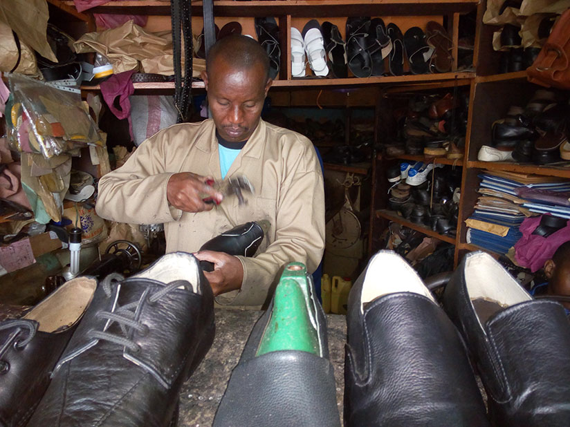 Bambanze putting final touches on a shoe at his workshop in Kigali. / Appolonia Uwanziga