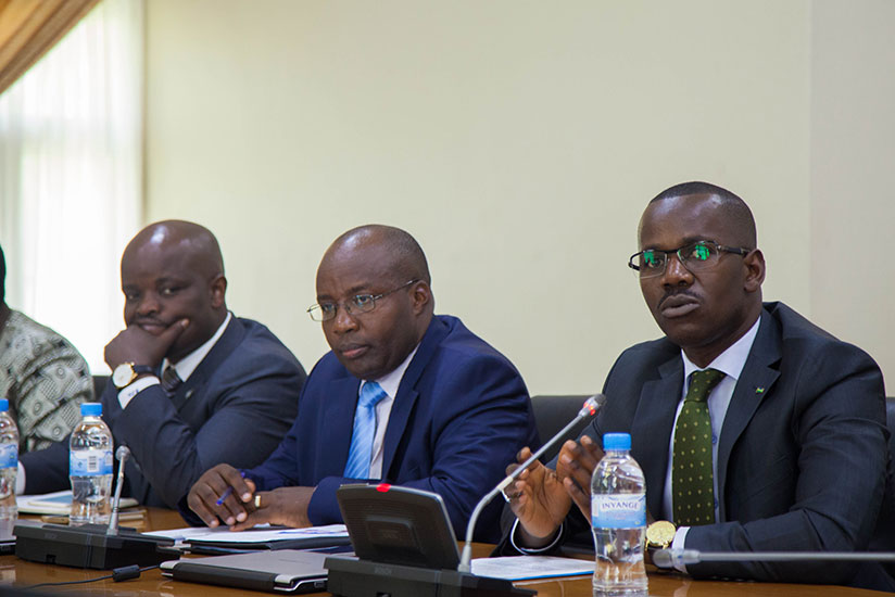 Uwizeyimana speaks at the news conference as Minister of State in charge of Transport, Dr Alexis Nzahabwanimana (C), and the Minister for Youth and ICT, Jean-Philbert Nsengimana, l....