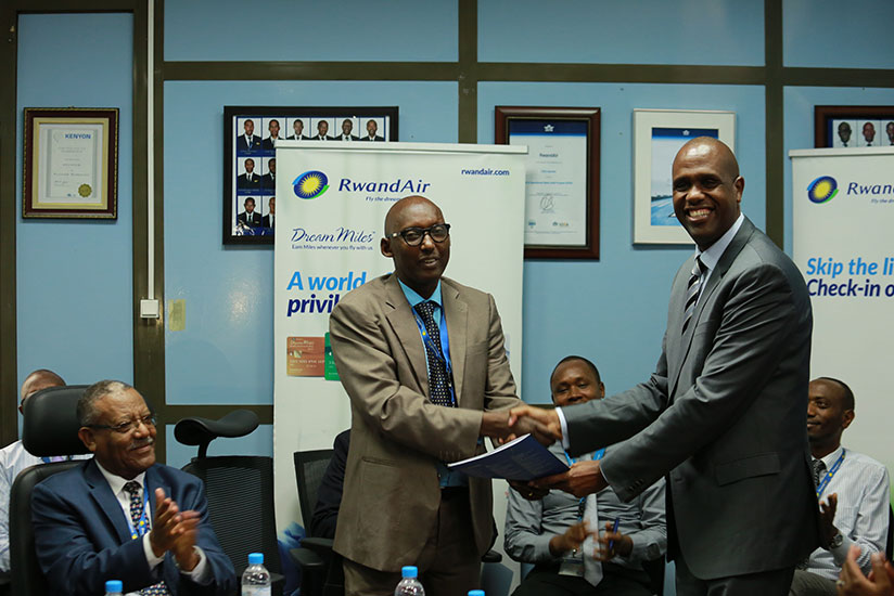 John Mirenge (R) handed over office to the new CEO Colonel Chance Ndangano at the Rwandair headquaters yesterday./ Timothy Kisambira