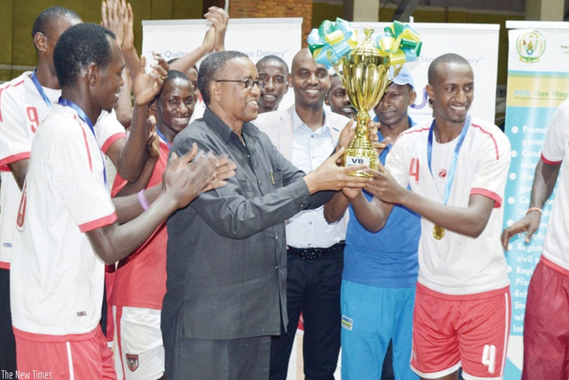 UNIK Vice Chancellor Prof. Silas Lwakabamba (C) lifts the Genocide Memorial Volleyball tournament trophy as players cheer on after winning it last year. (File)