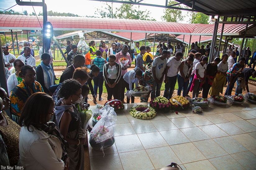 Relatives and friends of victims of the 1994 Genocide against the Tutsi lay wreaths on a grave at Nyanza Memorial Site on Tuesday. (All photos by Faustin Niyigena)