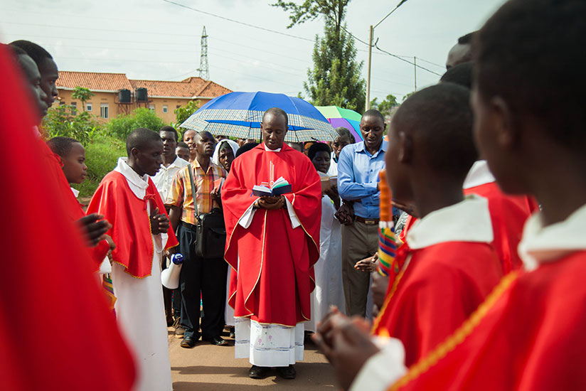 Fr. Eric Nzabamwita, the vicar of Kicukiro Parish in Kigali, delivers a sermon during a Way of the Cross procession on Good Friday. Story on page 3. Nadege Imbabazi. 