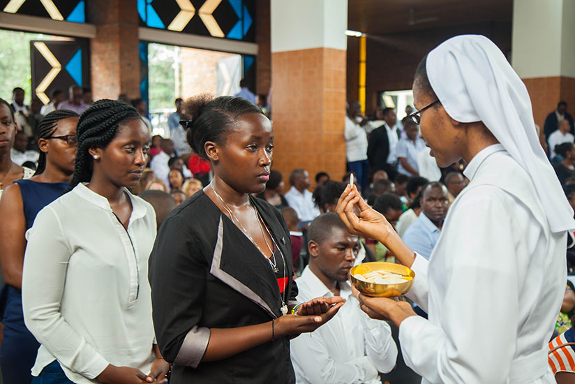 Christians take Holy Communion at St Michel Church during prayers to celebrate Easter Sunday, yesterday. / Nadege Imbabazi