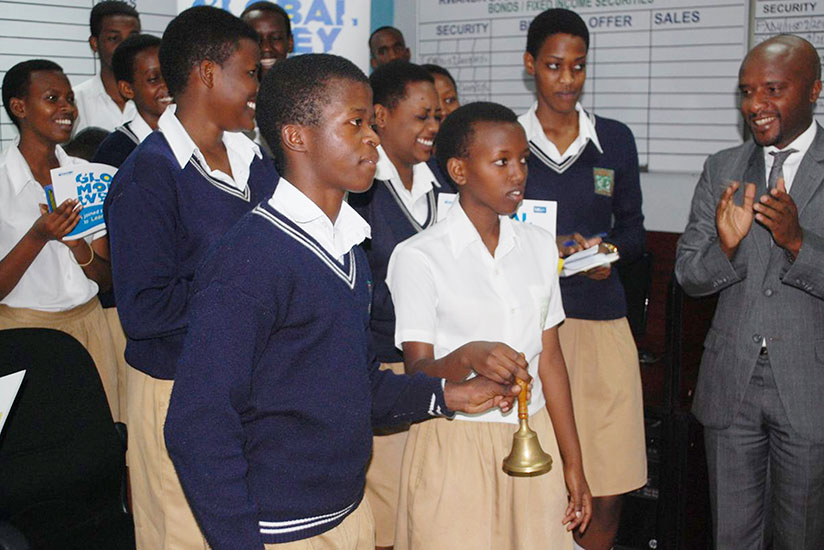 Students of Lycee de Kigali ring the bell at the beginning of a trading session last month as Celestin Rwabukumba (right), the RSE chief, cheers. There are ongoing sensitisation ca....