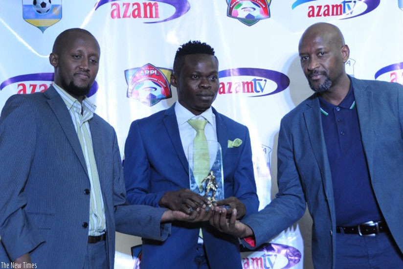Kwizera receives his award from FERWAFA president Vincent Nzamwita (R) and Azam Rwanda Operations Manager, Faradjallah Ndagano (L). File
