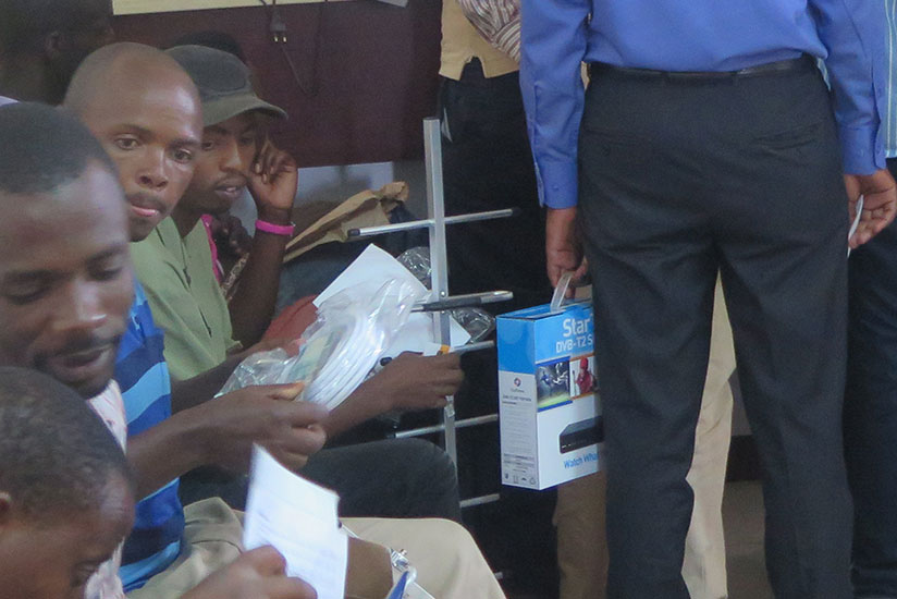 StarTimes customers checkout their decoders at the firm's head offices in Kigali during the digital migration era in 2014. / File