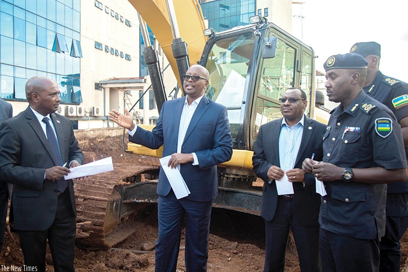 From L-R; Pascal Nyamulinda, the City of Kigali mayor; James Musoni, the minister for infrastructure; Claver Gatete, the minister for finance and economic planning; and Police spokesperson Theos Badege inspect a construction site where internet cables were damaged yesterday. (Photos by Nadege Imbabazi)