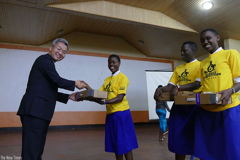 The KOICA Country Director Hyeong Lae Cho awards students who came in second in the secondary school science competitions. (Photos by John Mbaraga)