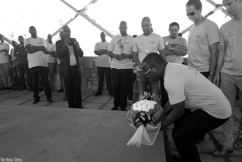 Madiela lays a wreath on the mass grave at Ntarama Memorial site on Tuesday.   (Appolonia Uwanziga)