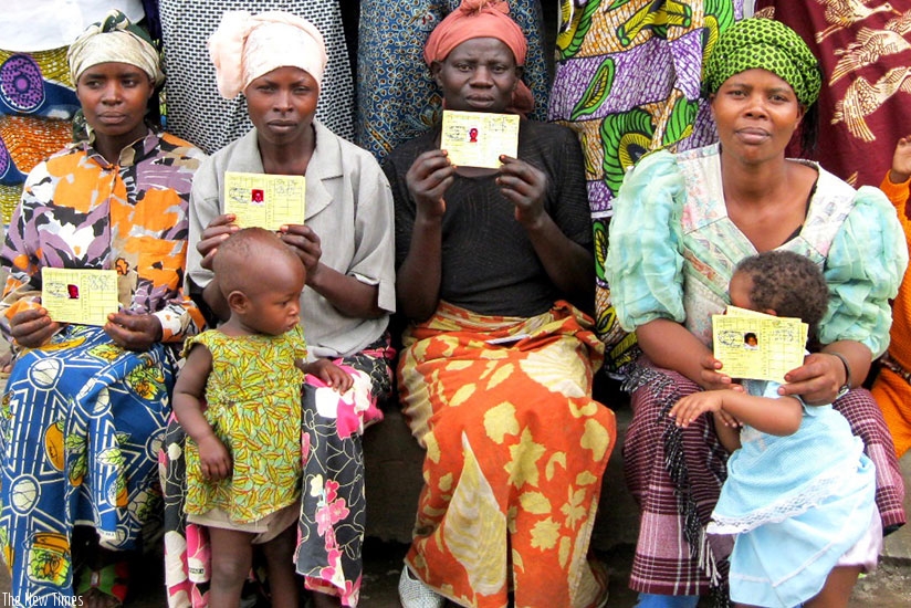 Mothers  pose in a group photo with there Mutuelle de Sante cards. (File)