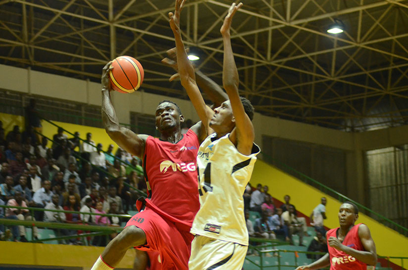 REG's Bienvenue Ngandu (left) goes for the basket against Patriots in the corresponding fixture, which the defending champions won 71-57. / Sam Ngendahimana