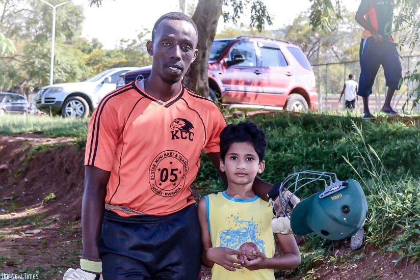 Mugisha poses for a photo with a young Kigali Cricket Club fan after a recent T20 game. Courtesy