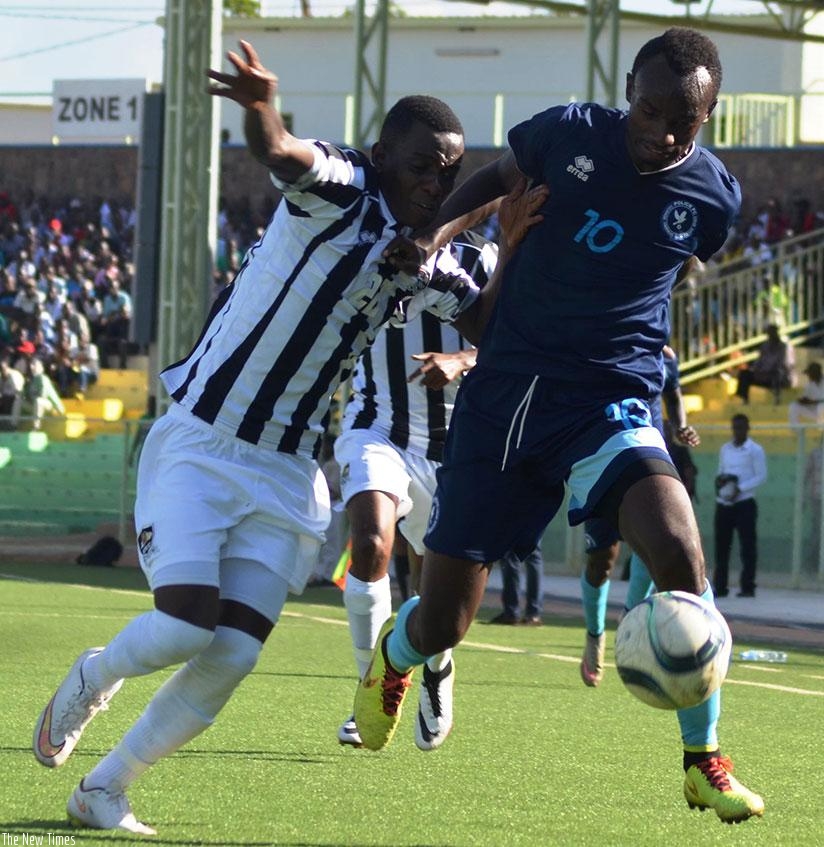 Police FC's league top scorer Dany Usengimana battles with APR full-back Michel Rusheshangoga during the first round fixture that ended in a 2-2 draw. S. Ngendahimana.