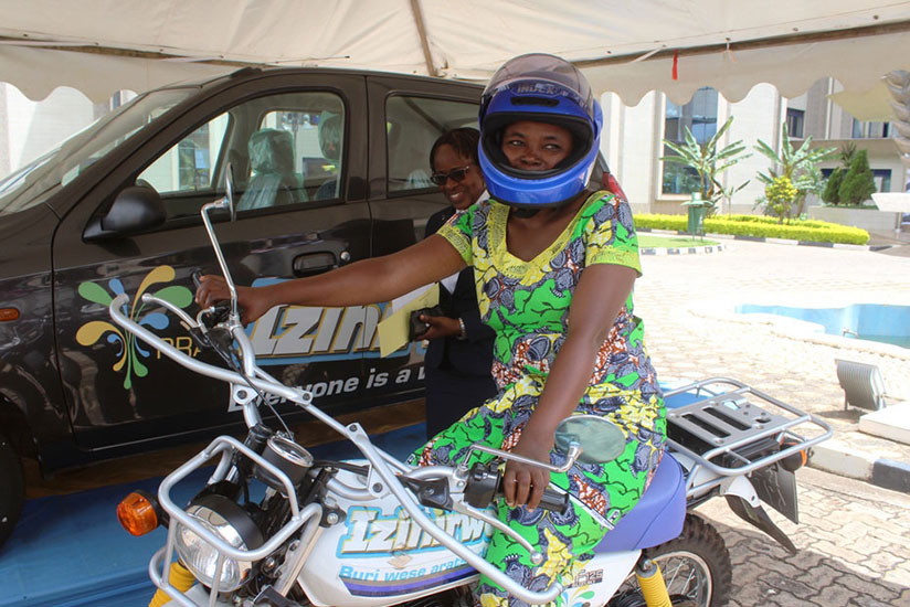 Kanyange poses with her motorcycle at RRA head offices. / Francis Byaruhanga