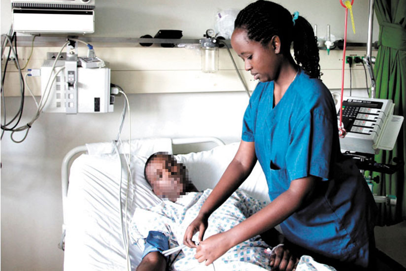 A nurse attends to a patient at a Kigali hospital. / File