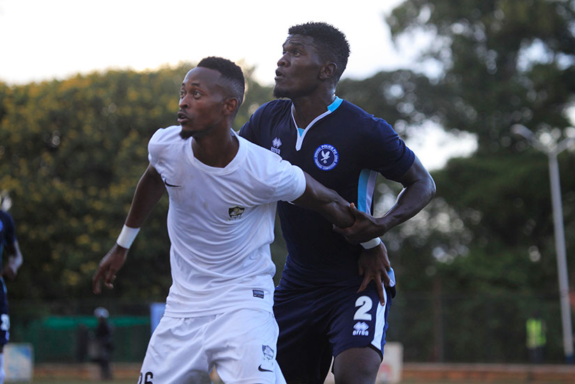 APR forward Issa Bigirimana (L) battles with Police defender Hussein Habimana during the match on Sunday, which ended 1-1. / Sam Ngendahimana
