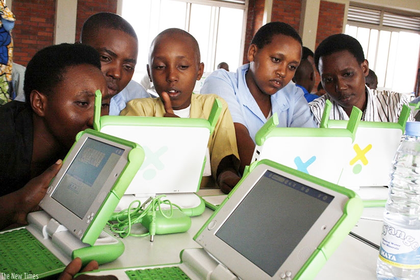 Pupils of Kimisagara Primary School use their laptops acquired under the One-Laptop-Per-Child project. (Timothy Kisambira)