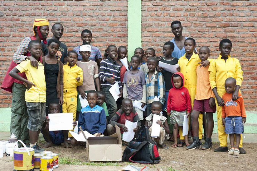 Zacharie Niyigena (back row, right), and Jean-Baptiste Rukundo (back row, third from left) with some of the children during one of the workshops. / Moses Opobo