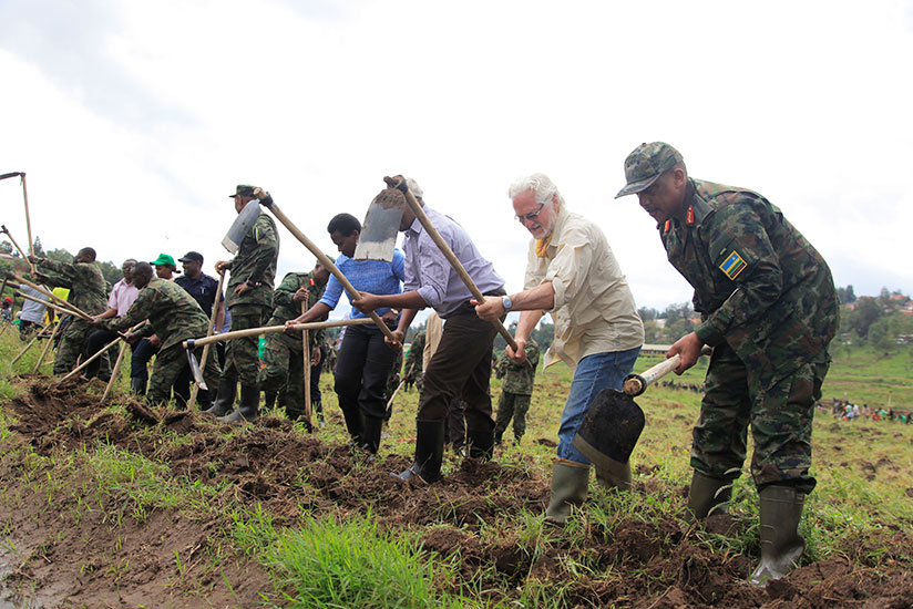 Chief of Defence Staff of RDF Gen Patrick Nyamvumba (far right) and other officials including Minister for Infrastructure James Musoni, during the launch of the Army week at Umushumba Mwiza marshland in Kicukiro. / Sam Ngendahimana