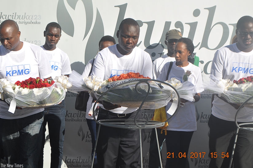 Ineget (C) and some staffers lay wreaths on graves at Kigali Genocide Memorial. Courtesy. 