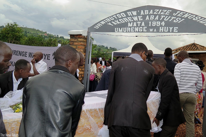 Pallbearers carrying one of the coffins containing the remains of over 35,000 vctims of genocide against the Tutsi, for a decent burial in Rukira Genocide memorial site  in Huye District.