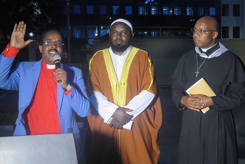 Bishop Innocent Nzeyimana (L), Sheikh Kassim Nzanahayo (C) and Father Gerrard Nshagayimana beg pardon to a genocide survivor on behalf of religious communities. / Eddie Nsabimana
