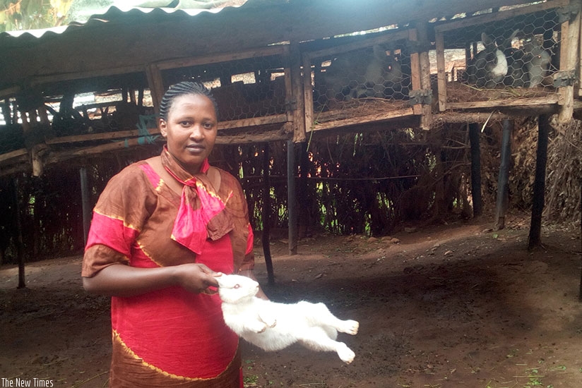 Mukandoli poses with one of her rabbits. The farmer has over 2000 rabbits.  (Photos: Remy Niyingize)