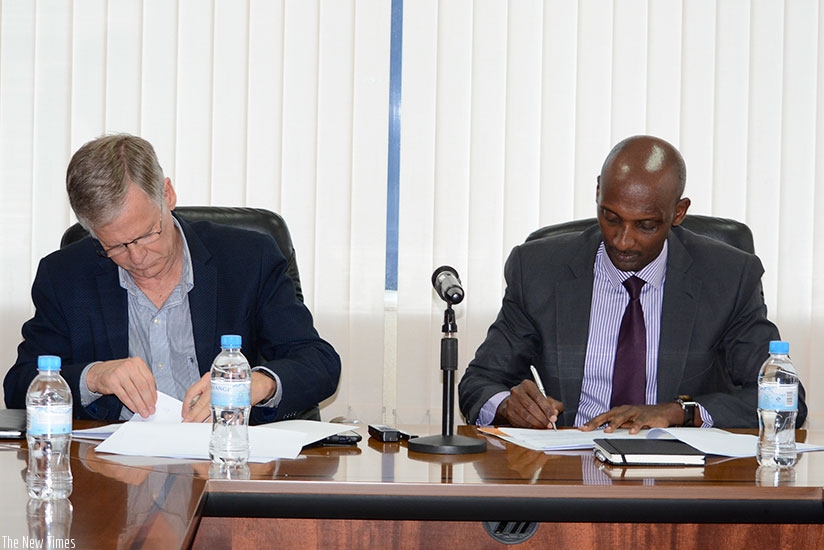 Prof. Krogh (L) and Tusabe sign the Memorandum of Understanding in Kigali, yesterday. (Courtesy)
