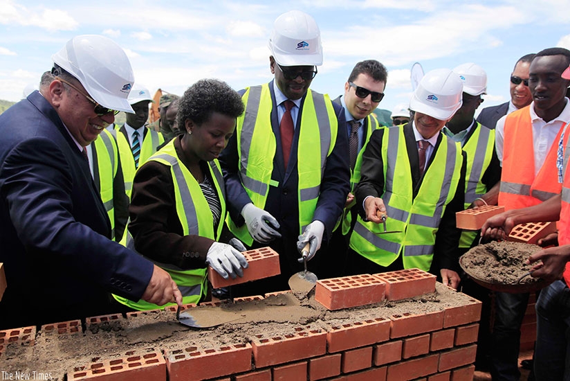 (L-R) Chairman of the Board of Hakan AS ,Ahmet Karasoy, State Minister Kamayirese, Minister Musoni  lay a foundation stone where the 80MW Peat-Fired Power Plant will be constructed. ( All photos by Sam Ngendahimana)
