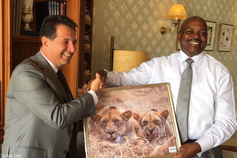 Amb. Nkurunziza (R) hands over a gift to Tarek Ragheb. (Courtesy)