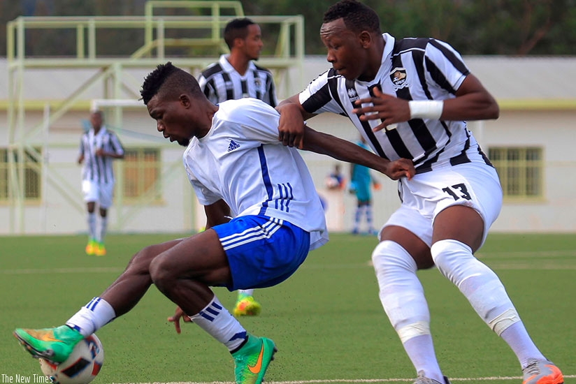 Pepiniere FC's Michel Nduwimana controls the ball against APR  defender Aimable Nsabimana during a recent league match at  Kigali Stadium. (Sam Ngendahimana)