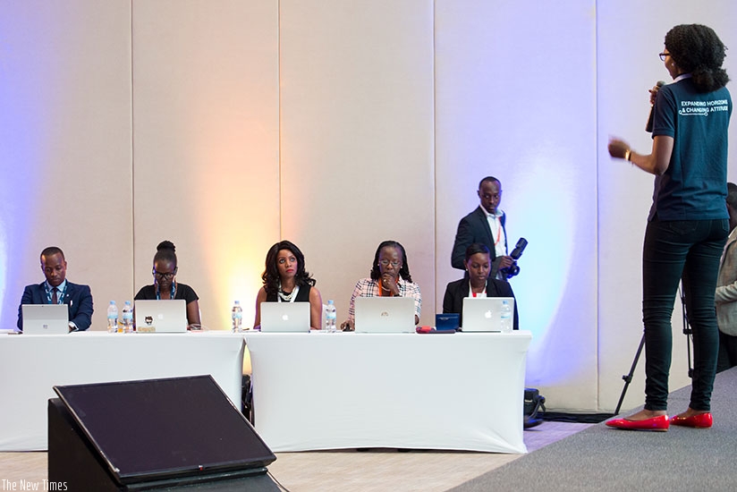 Judges listen to Waiganjo from University of Nairobi of Kenya as she  presents her project.  (Photos by Timothy Kisambira)