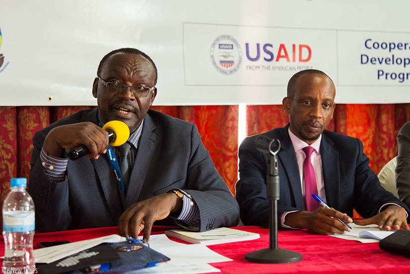 Kanimba (L) speaks during a cooperative consultative meeting as Munanura looks on. N. Imbabazi.
