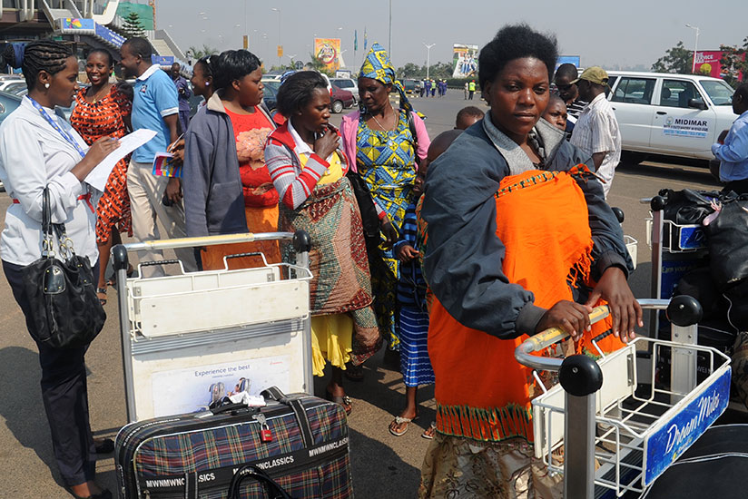 Returnees from Mali arrive at Kigali International Airport in 2013. / File