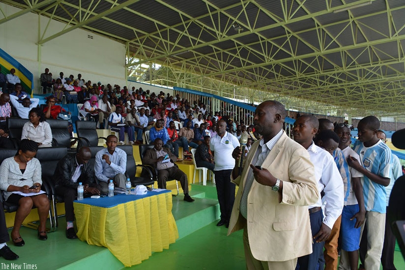 Members of cooperatives queue to ask questions during the meeting. (Steven Muvunyi)