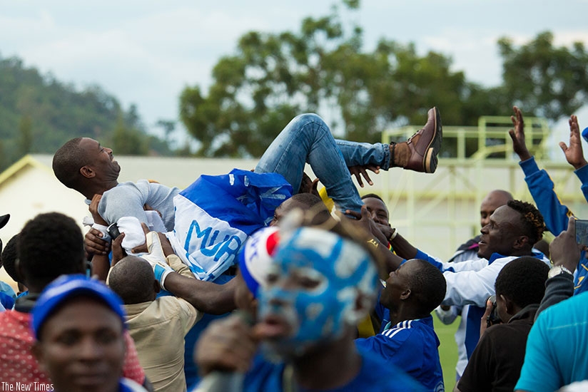 Rayon Sports coach Djuma  Masudi is carried shoulder-high by his players after winning the league on Wednesday at Stade de Kigali. (Timothy Kisambira)