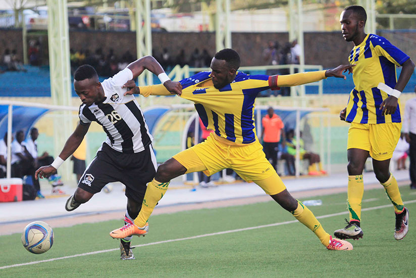APR FC forward Issa Bigirimana battles for the ball as Kigali City's side defenders try to block him during a 1-1 draw yesterday. / Sam Ngendahimana
