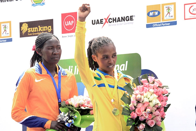 Salome Nyirarukundo  celebrates on the podium. The 20-year old beat Sheilla Chesang from Kenya to win Gold in the Women's half marathon yesterday. S. Ngendahimana