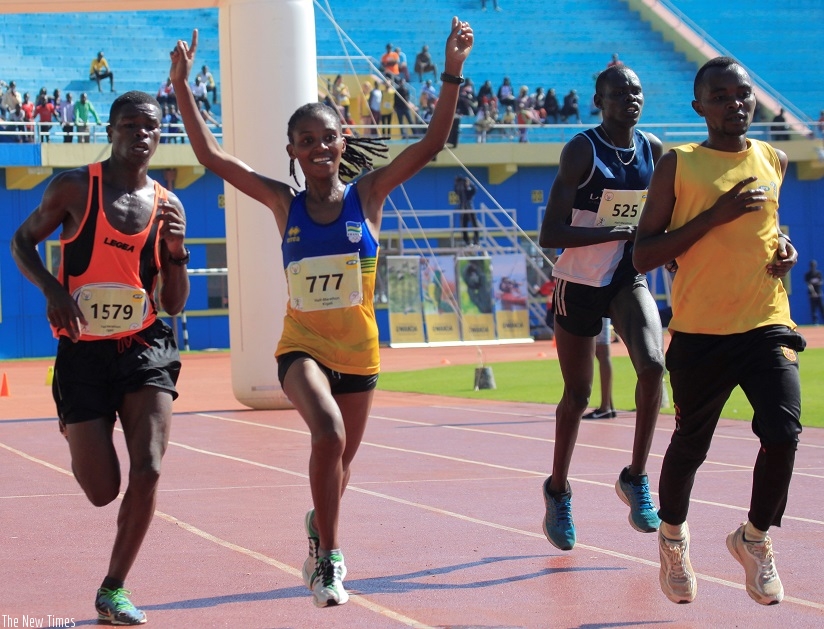 Salome Nyirarukundo celebrates her crucial victory in the Kigali InternationalPeace Marathon on Sunday at Amahoro National Stadium. Sam Ngendahimana