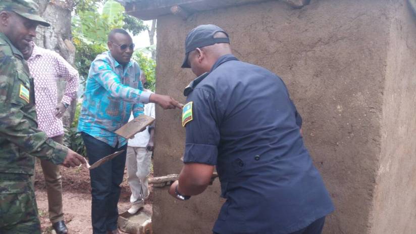State Minister in charge of Primary and Secondary Education, Isaac Munyakazi, DIGP Juvenal Marizamunda joined by Nyaruguru residents to construct one of the 36 toilets.