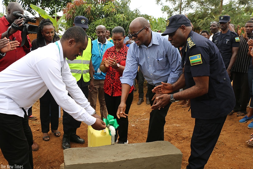Minister James Musoni inagurating a water source in Gatare Village. (Photos by Kelly Rwamapera)
