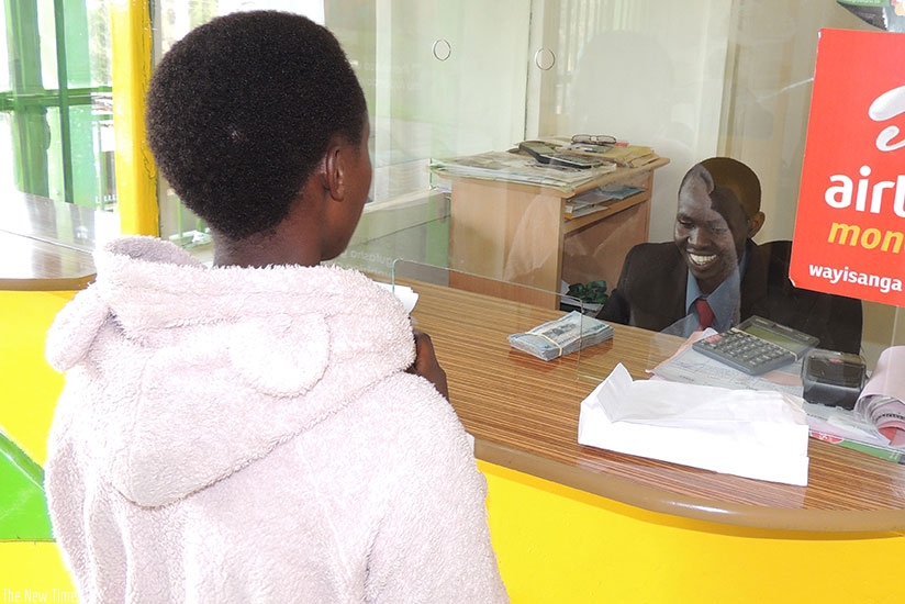 A customer being served at CIC, a Kicukiro-based microfinance institution.  (File)