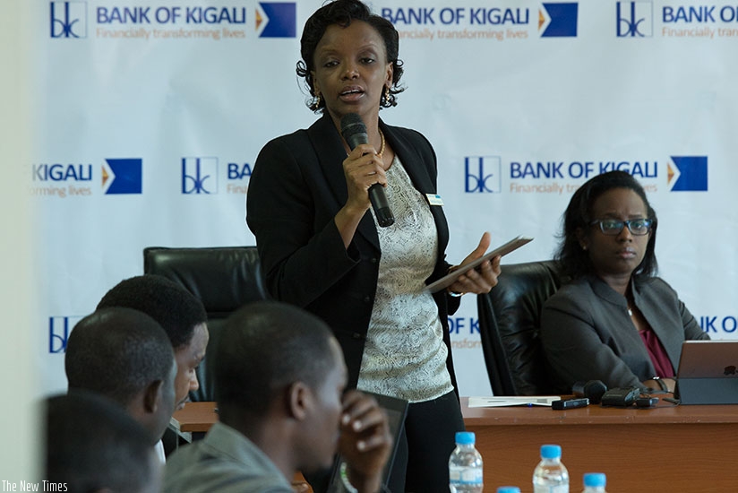 Nathalie Mpaka, Bank of Kigali chief financial officer, makes a presentation during a news conference as Dr Diane Karusisi,  the chief executive (R), follows yesterday. (Photos by Timothy Kisambira)