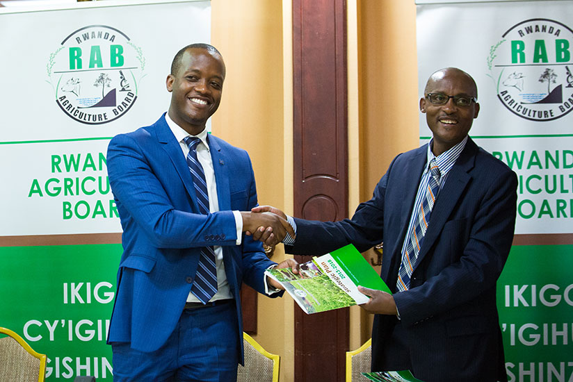 Regemanshuro (left) and Bagabe exchange documents after signing the deal. / Timothy Kisambira