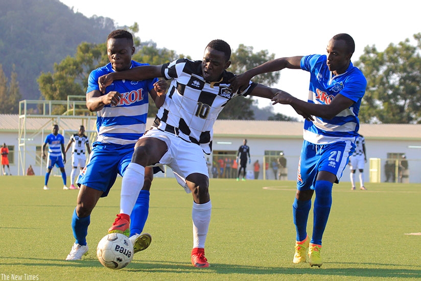APR FC attacking midifielder Hakizimana (C) vies for the ball with Rayon Sports' players in the 1-1 draw at Stade de Kigali last Sunday. rn(Sam Ngendahimana)