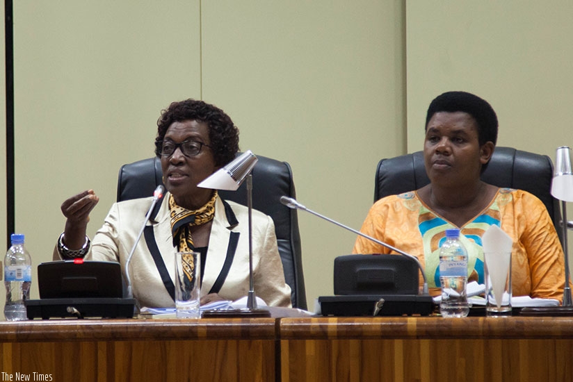 MP Rwaka (L) speaks during the plenary session in Parliament as deputy chairperson of the committee Annonciata Mukarugwiza looks on. (Nadege Imbabazi)